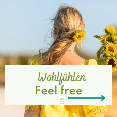 Man sieht eine Frau mit gelbem Kleid, und Sonnenblumen und blonden langen Haaren draussen von hinten: Wohlfühlen, Feel free ist das Thema im Lymphbalance Newsletter von Jeannine Gashi.